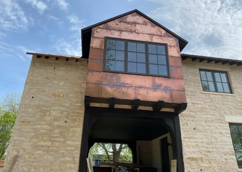 Copper metal panel facade on a stone building for Roof Repair in East Hills