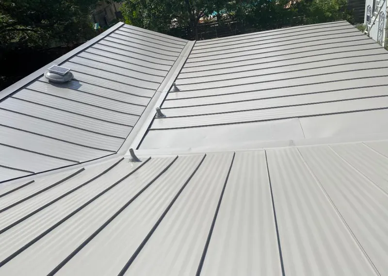 Solar attic fan installed on a metal roof for Roof Ventilation in East Hills